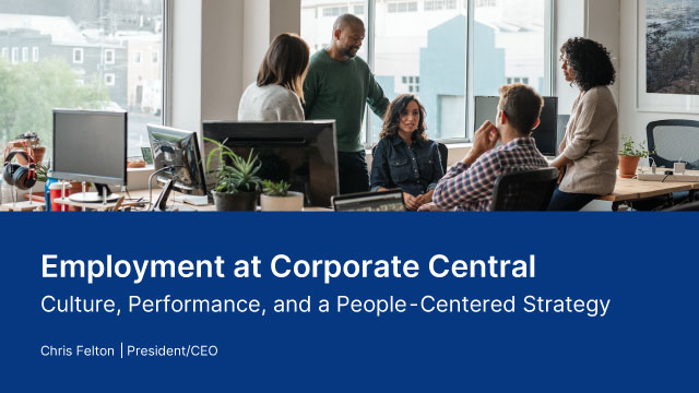 Photo of a group of people around a desk working together.