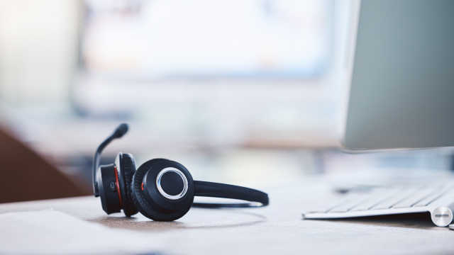 Photograph of tech support headset on a desk.