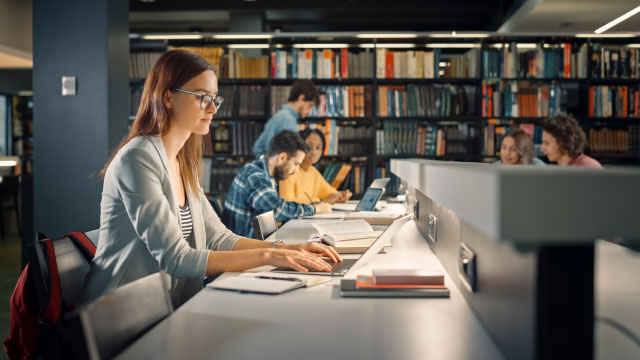 College students studying in a library.